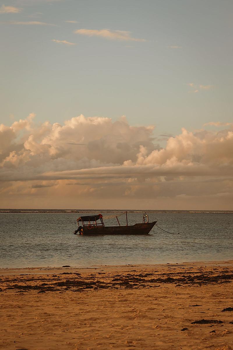 Fishing dhow silhouetted against a Zanzibar sunset on the Indian Ocean